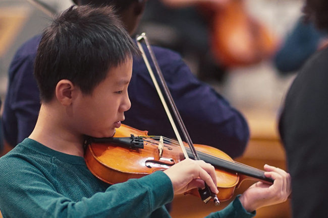 Boy playing violin banner image